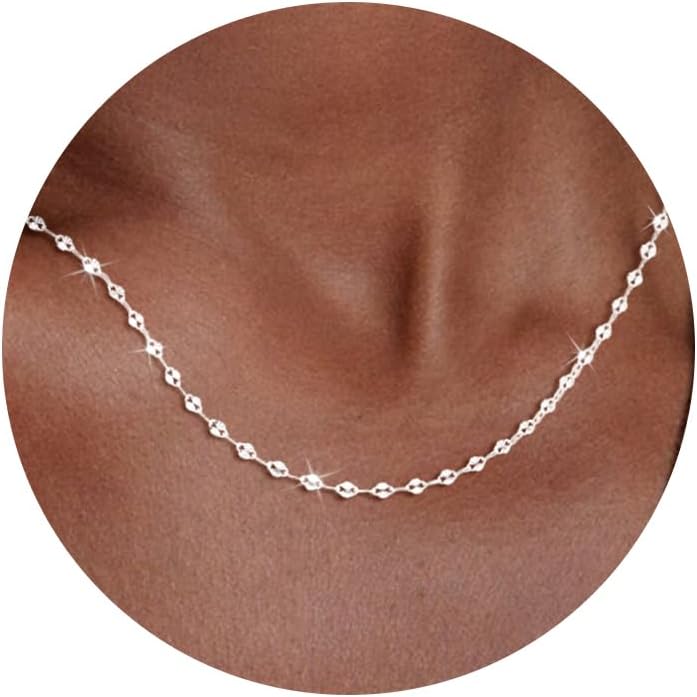 Fine flat mirror-link chain necklace worn at the collarbone