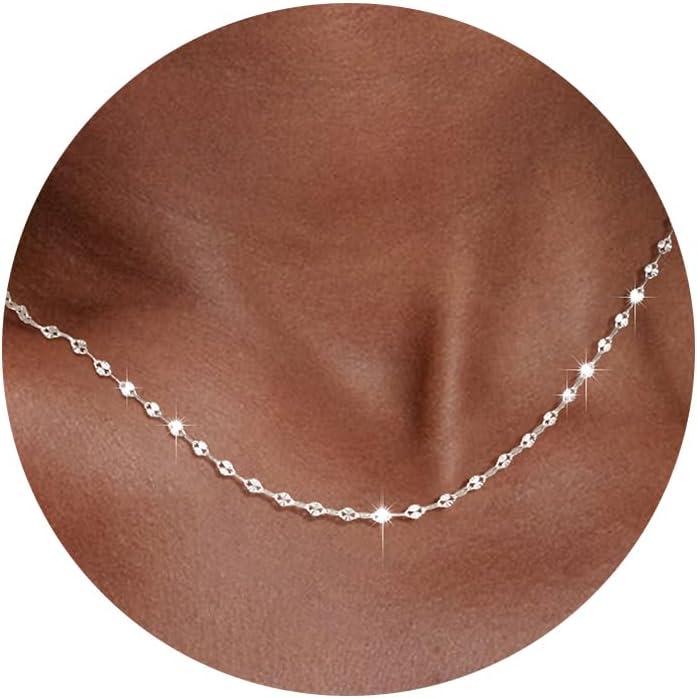 Fine flat mirror-link chain necklace worn at the collarbone