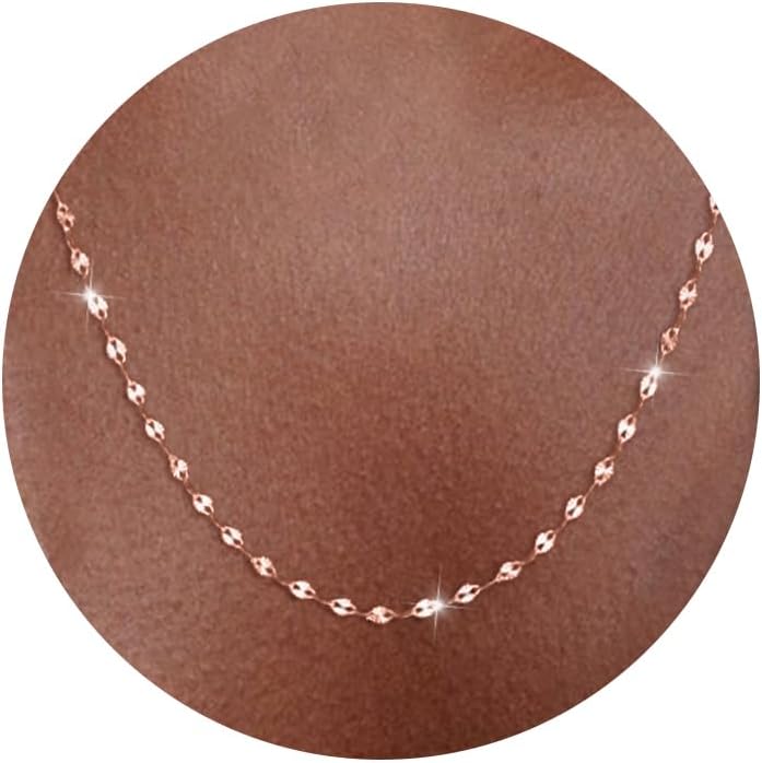 Fine flat mirror-link chain necklace worn at the collarbone