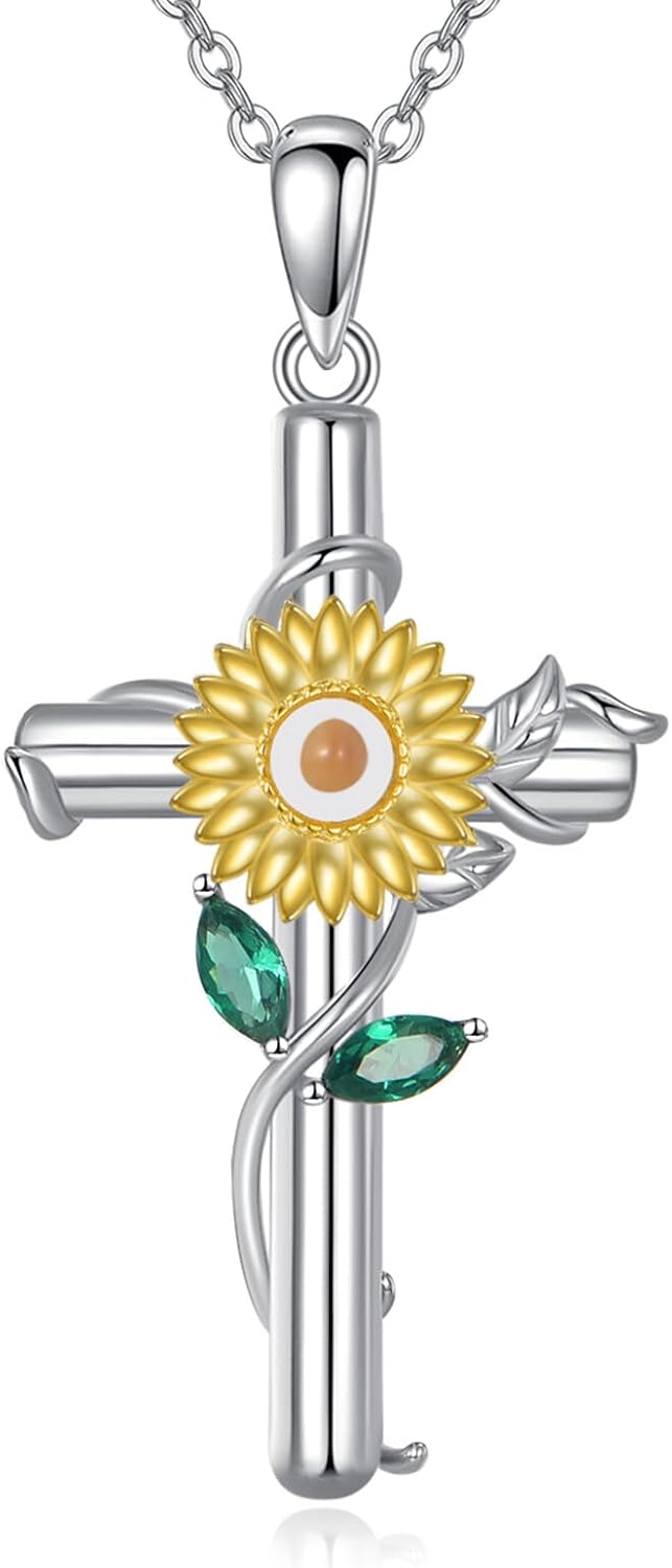 Silver-tone cross pendant with a leaf vine and an enamel birth flower