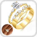 Two slim gold-tone stacking bands, one set with an oval stone