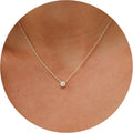 Dainty necklace with one round stone in a bezel on a fine chain