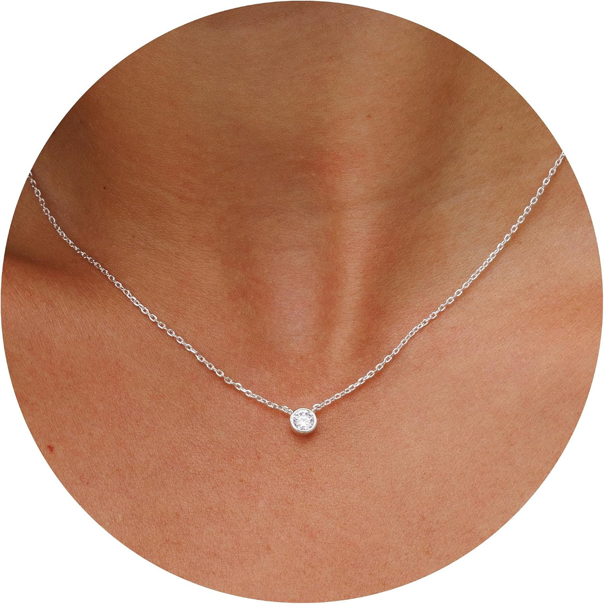 Dainty necklace with one round stone in a bezel on a fine chain