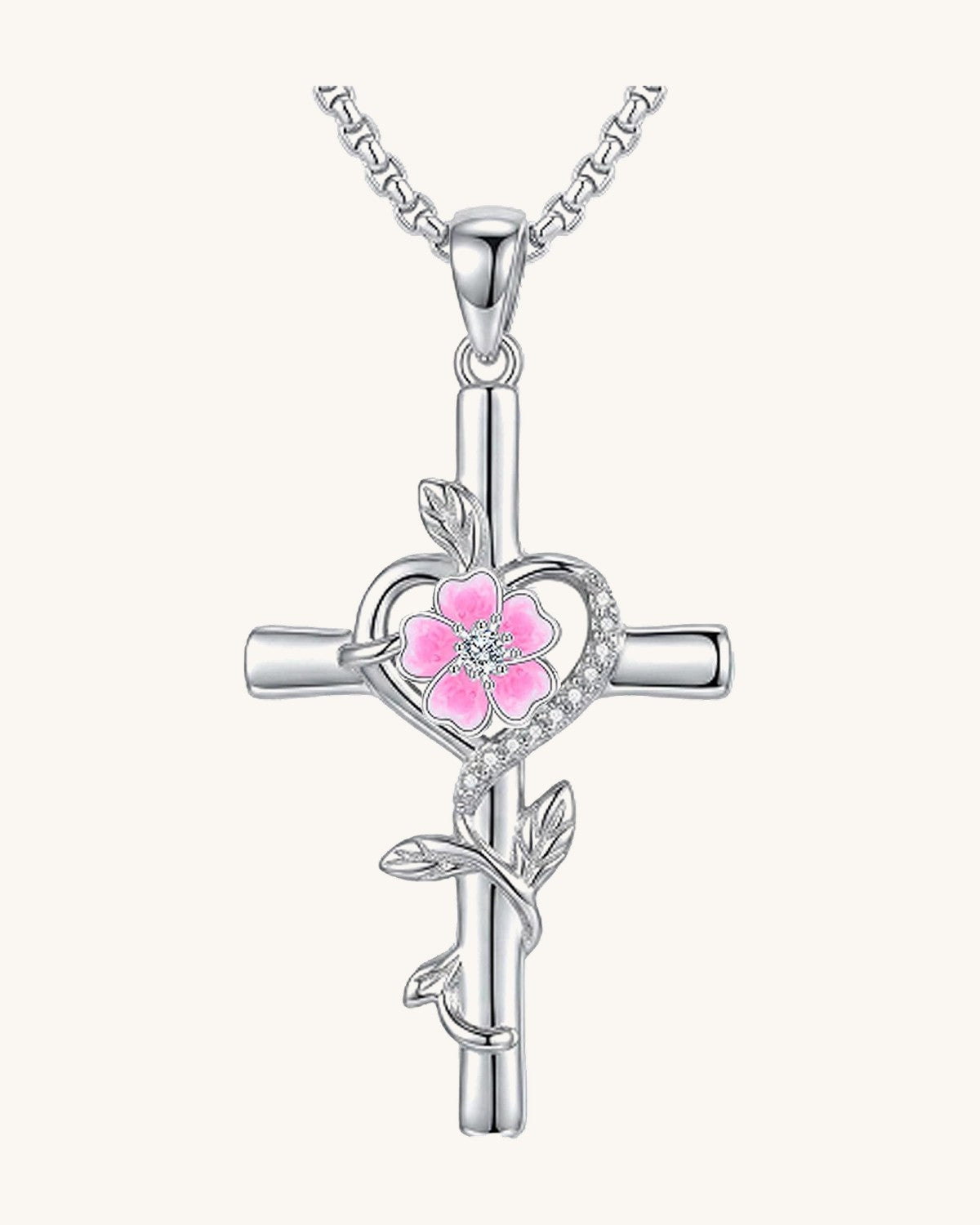 Silver-tone cross pendant with a leaf vine and an enamel birth flower