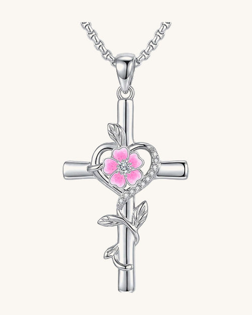 Silver-tone cross pendant with a leaf vine and an enamel birth flower