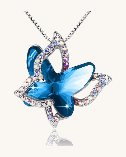 Faceted crystal butterfly pendant with a pave silver-tone wing overlay