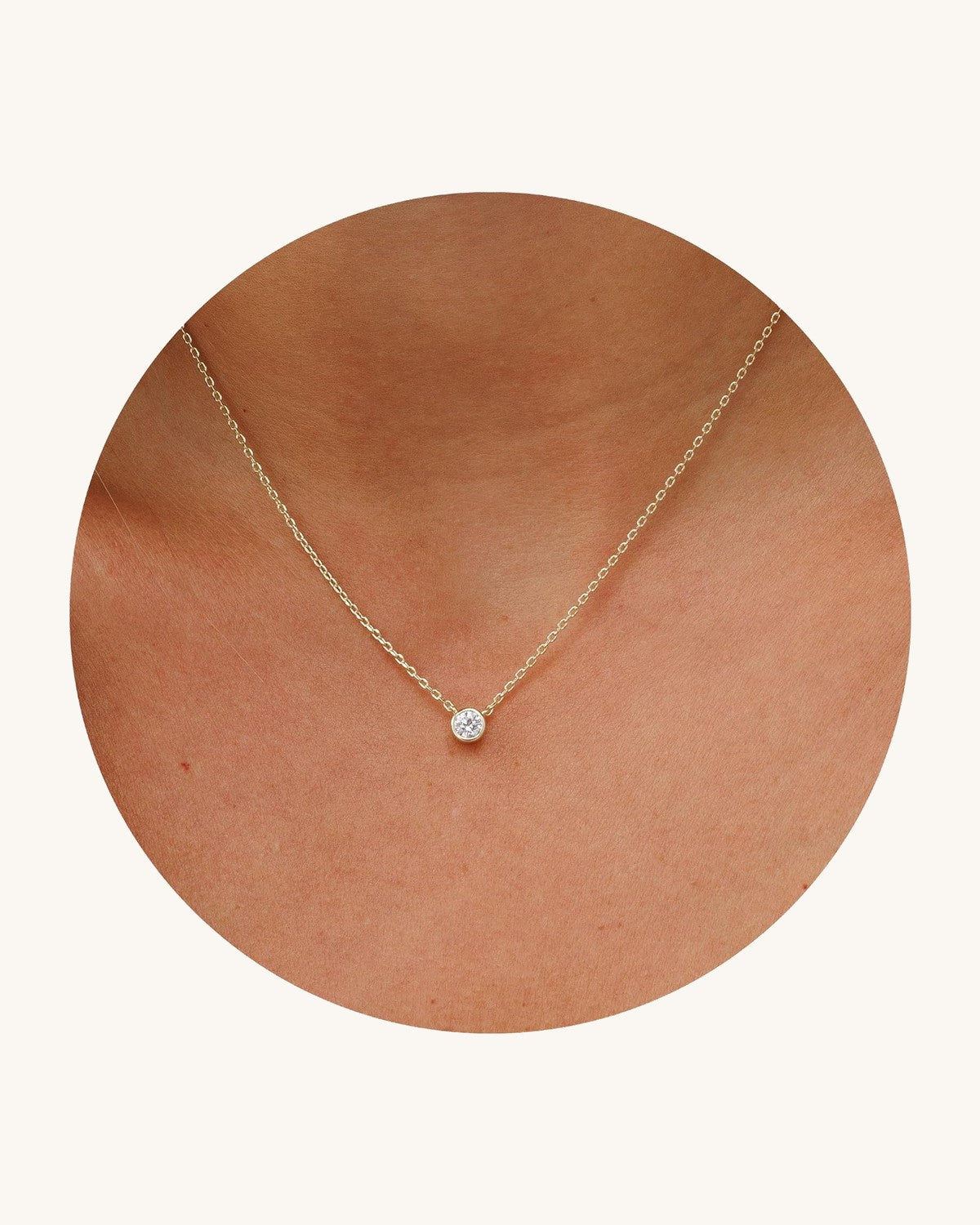 Dainty necklace with one round stone in a bezel on a fine chain