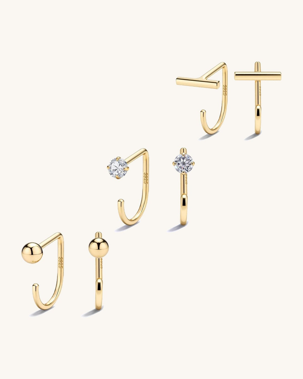 Small half hoop huggie earrings shown in several designs