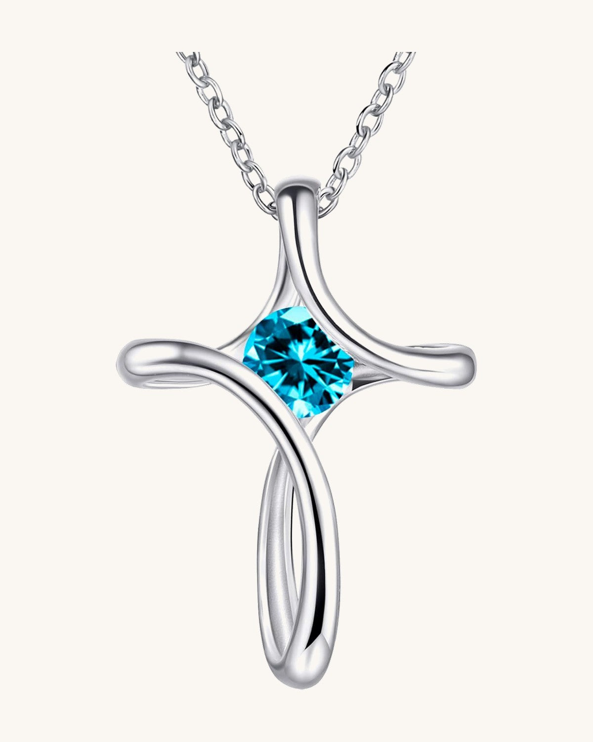 Silver-tone looped cross pendant with a round birthstone-color crystal